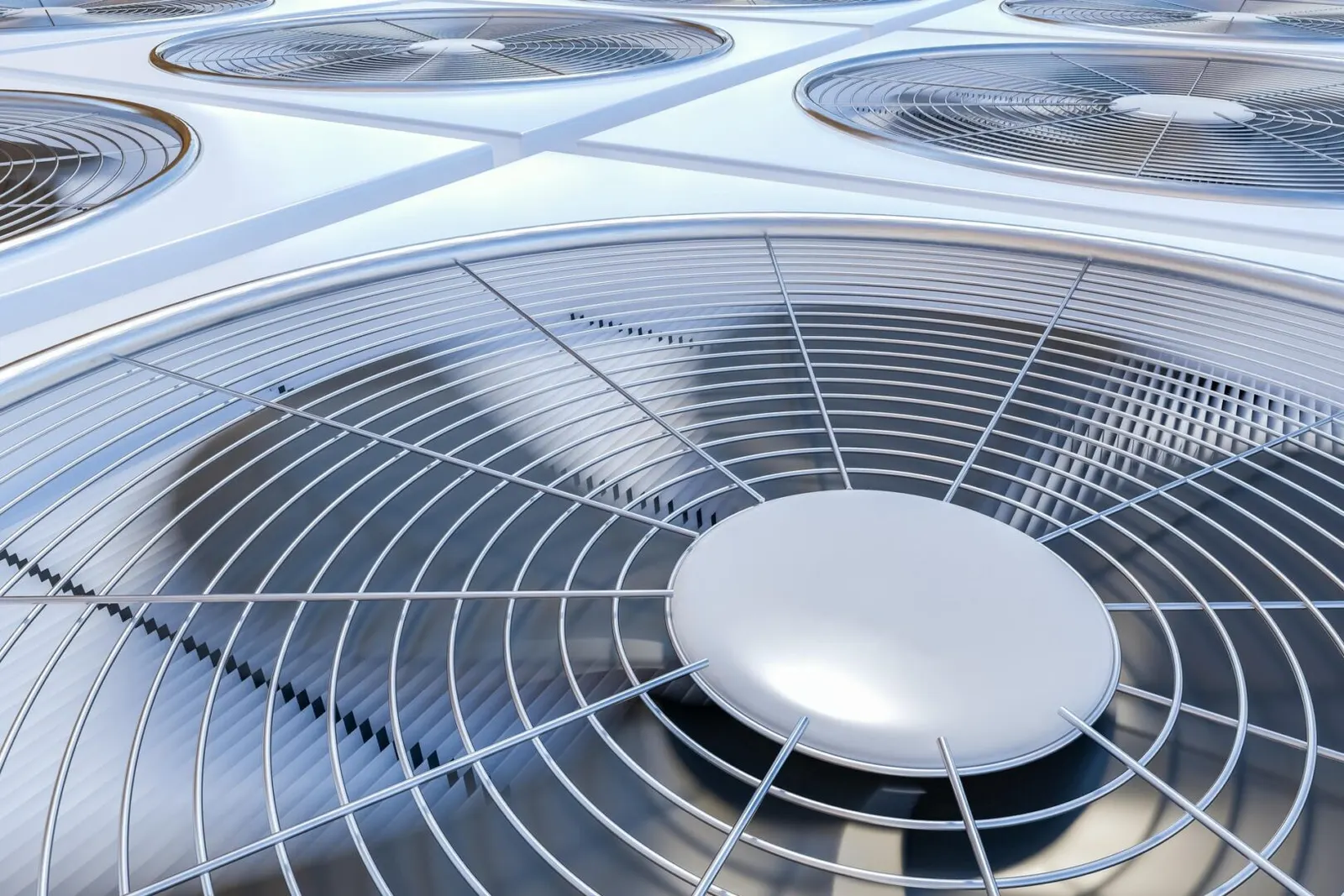 Outdoor air conditioning condenser units with protective fan grilles